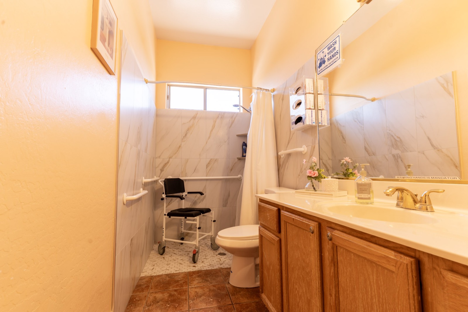 A clean, accessible bathroom with grab bars and roll-in shower